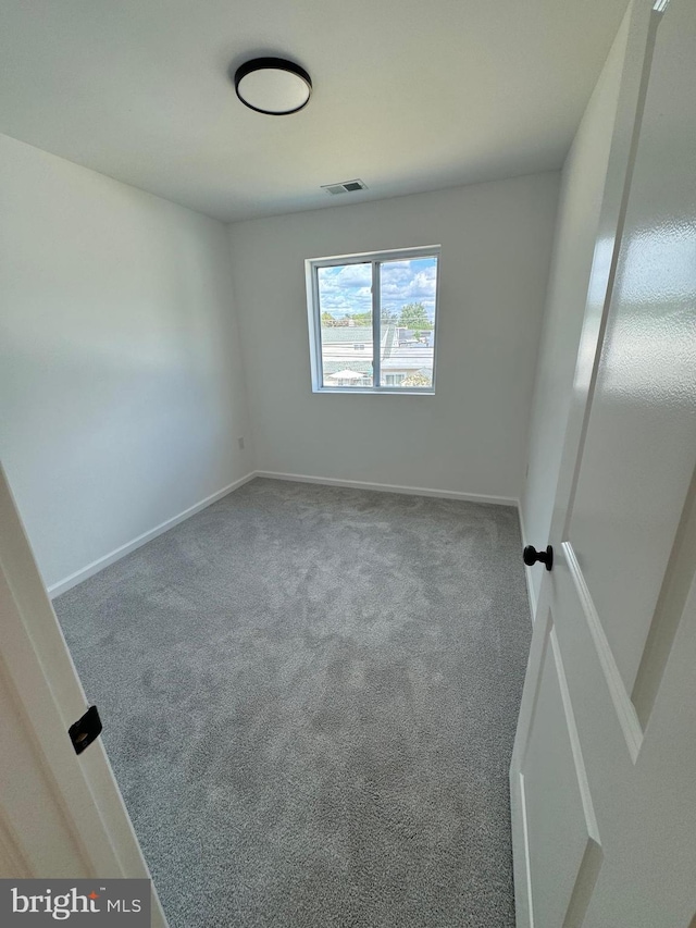 unfurnished room featuring carpet