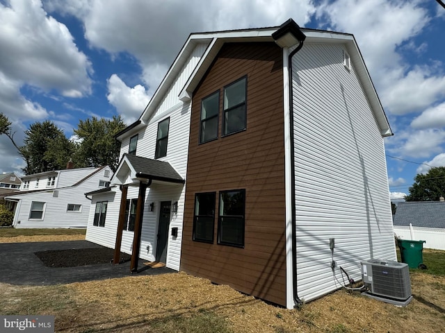 view of side of property featuring central air condition unit