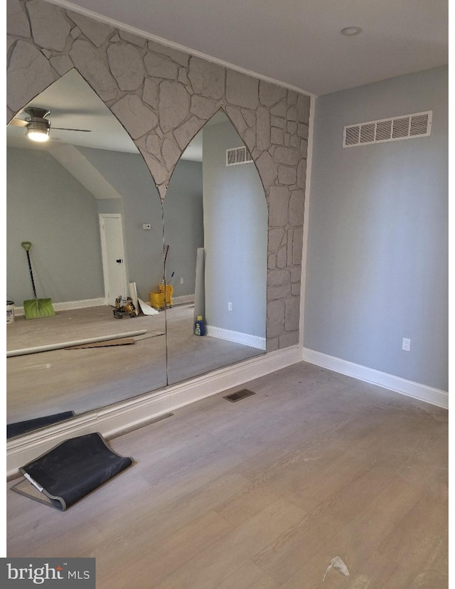 spare room featuring ceiling fan and light hardwood / wood-style flooring