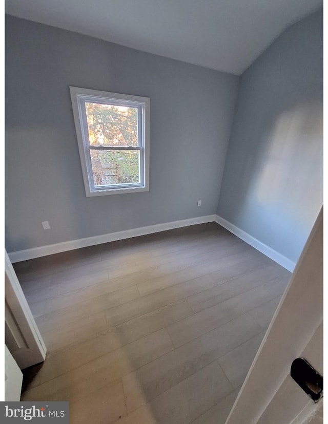 empty room with light hardwood / wood-style flooring