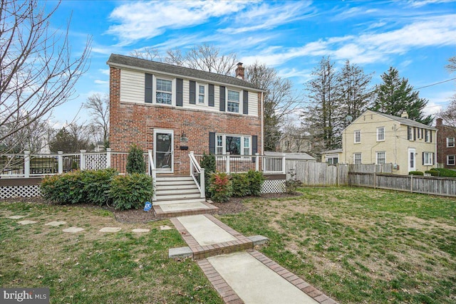 view of front of house featuring a front yard and a deck