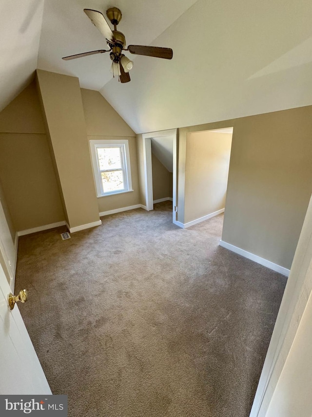 additional living space featuring ceiling fan, carpet, and lofted ceiling