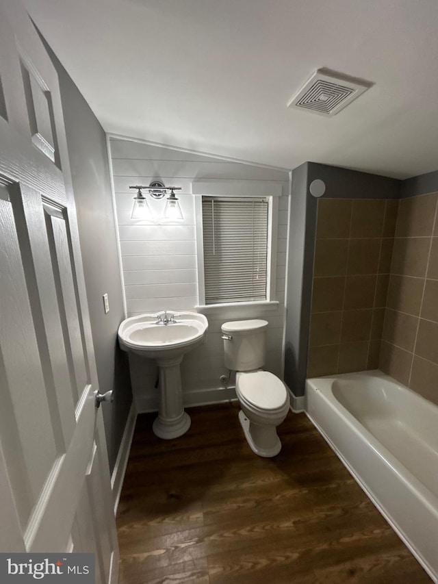 bathroom with hardwood / wood-style flooring and toilet