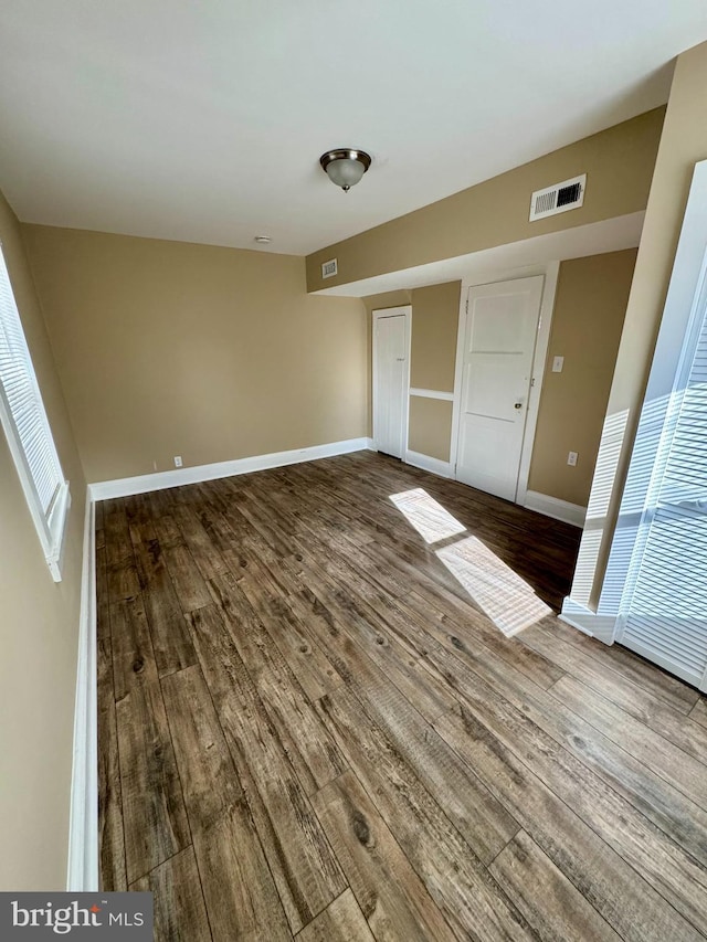 empty room with hardwood / wood-style floors