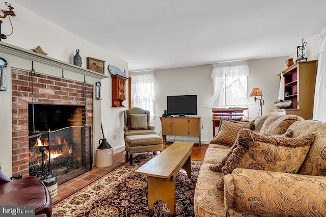 tiled living room featuring a fireplace and a healthy amount of sunlight