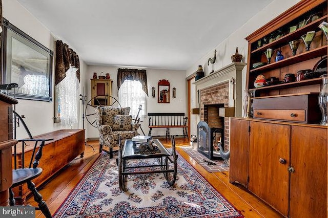 living room featuring a fireplace and light hardwood / wood-style flooring