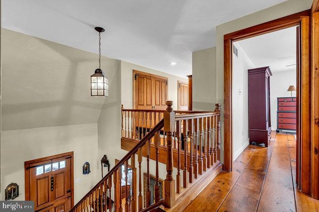 corridor with hardwood / wood-style flooring