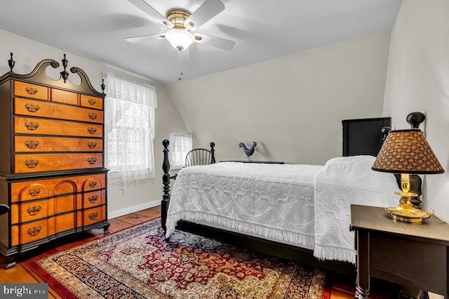 bedroom featuring ceiling fan, hardwood / wood-style floors, and lofted ceiling