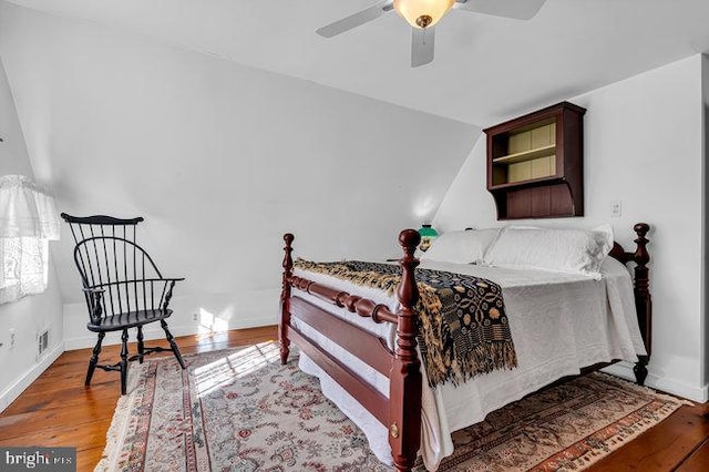 bedroom with ceiling fan, hardwood / wood-style floors, and lofted ceiling