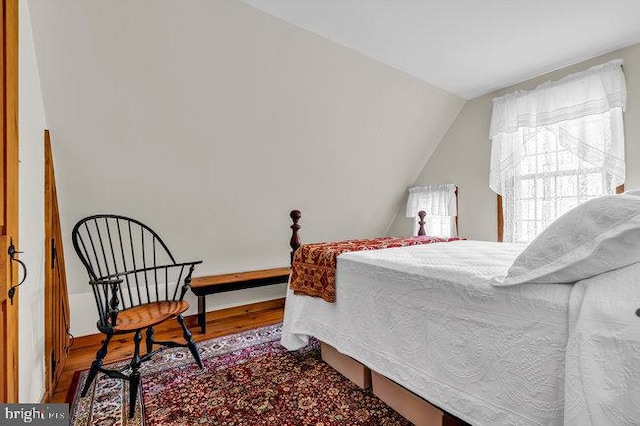 bedroom featuring hardwood / wood-style floors and lofted ceiling