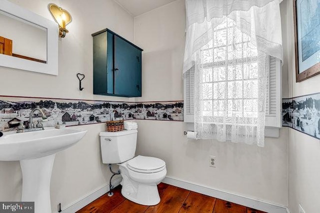 bathroom featuring hardwood / wood-style flooring, toilet, a healthy amount of sunlight, and sink