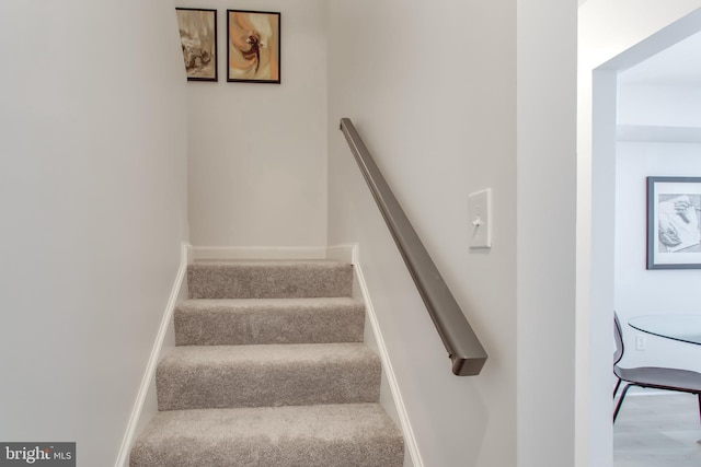 staircase with wood-type flooring