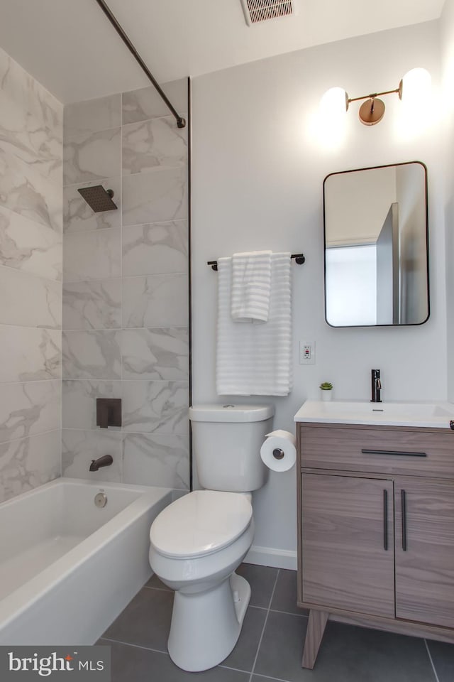 full bathroom featuring tile patterned floors, vanity, toilet, and tiled shower / bath