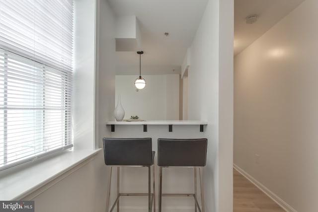 interior space featuring decorative light fixtures and light hardwood / wood-style floors