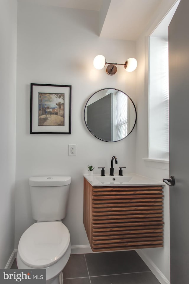 bathroom with tile patterned floors, vanity, and toilet