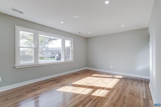 empty room with light hardwood / wood-style flooring