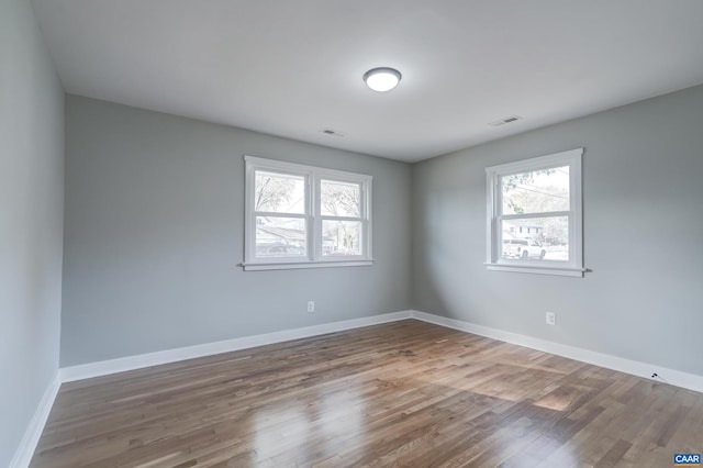 unfurnished room featuring hardwood / wood-style flooring