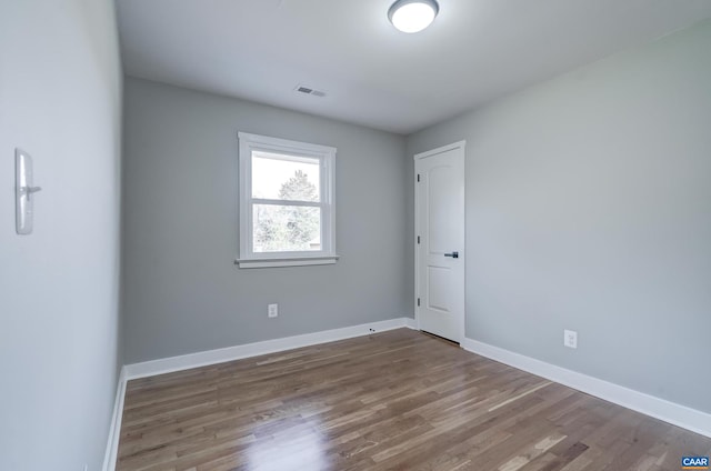 empty room featuring hardwood / wood-style flooring