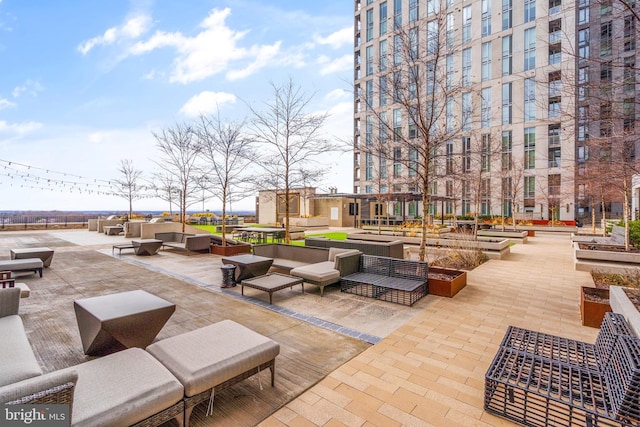 view of property's community featuring an outdoor hangout area and a patio area