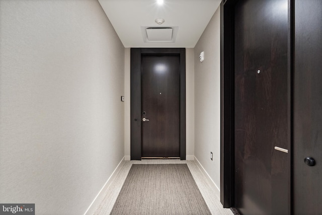 entryway featuring light colored carpet