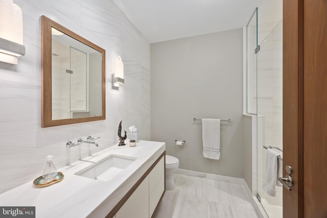 bathroom featuring vanity, toilet, and an enclosed shower