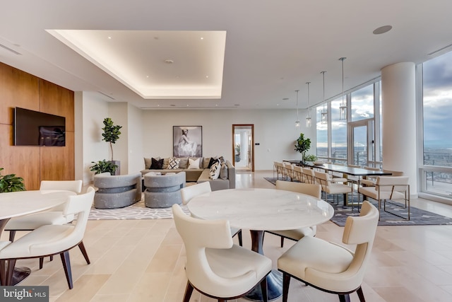 dining space featuring a tray ceiling