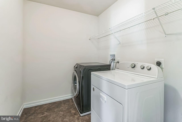 clothes washing area with washer and clothes dryer