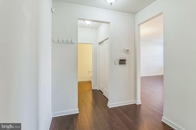 hallway with dark wood-type flooring