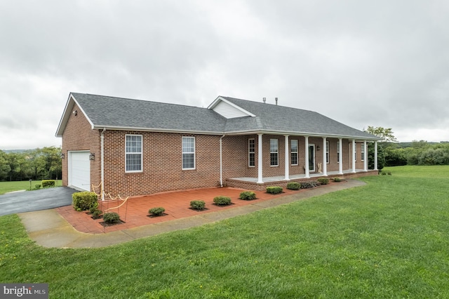 view of front facade with a front lawn, a porch, and a garage