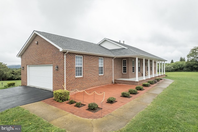 view of side of home with a lawn and covered porch