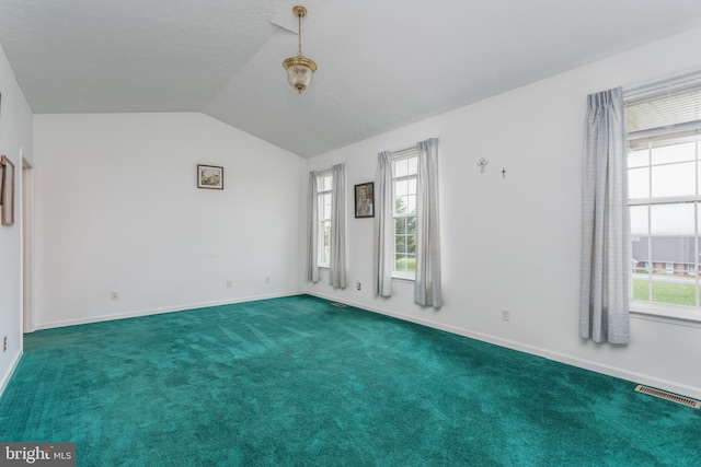 unfurnished room with dark colored carpet and lofted ceiling