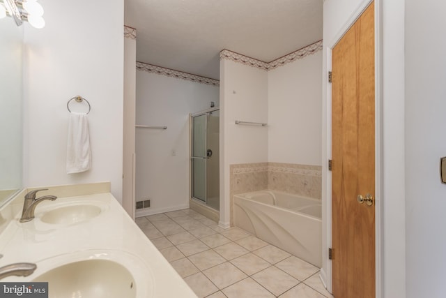 bathroom featuring tile patterned flooring, vanity, a textured ceiling, and independent shower and bath