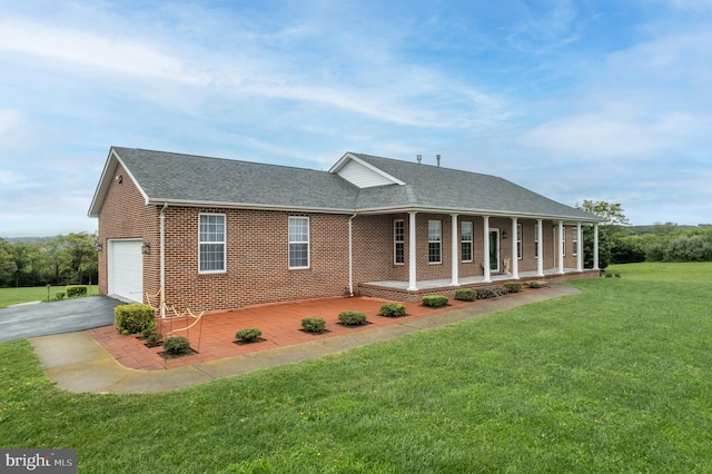 view of front of house with a front lawn, a porch, and a garage