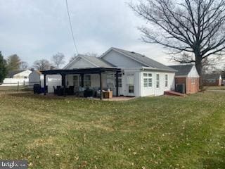 rear view of house with a yard