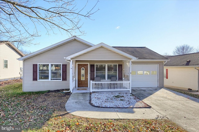 ranch-style house featuring covered porch and a garage