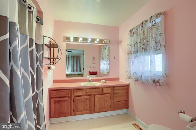 bathroom featuring vanity and toilet