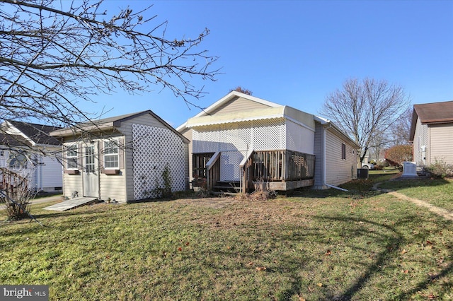 rear view of property with a lawn