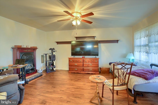 living room featuring ceiling fan and light wood-type flooring