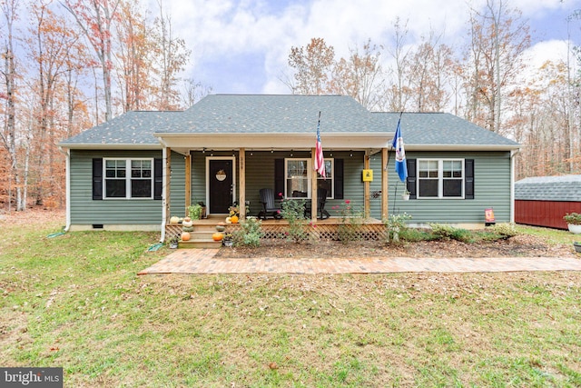 view of front of home with a front yard and a storage unit