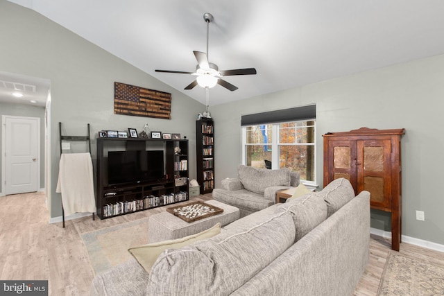 living room with ceiling fan, light wood-type flooring, and lofted ceiling