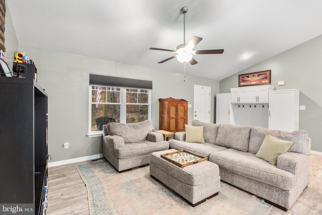 living room with light hardwood / wood-style floors, ceiling fan, and lofted ceiling