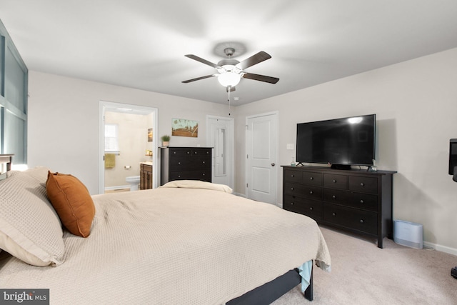 carpeted bedroom featuring ensuite bath and ceiling fan