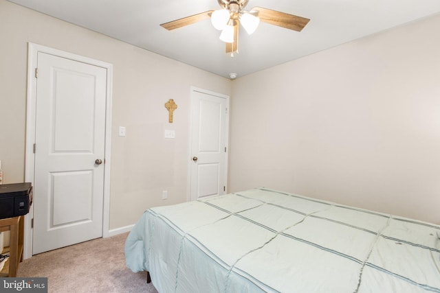 bedroom featuring ceiling fan and light colored carpet