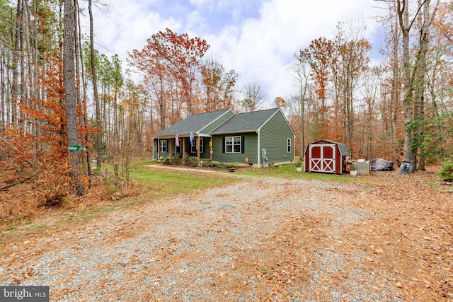 view of front facade featuring covered porch and a storage shed