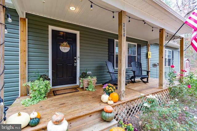 view of exterior entry with a porch