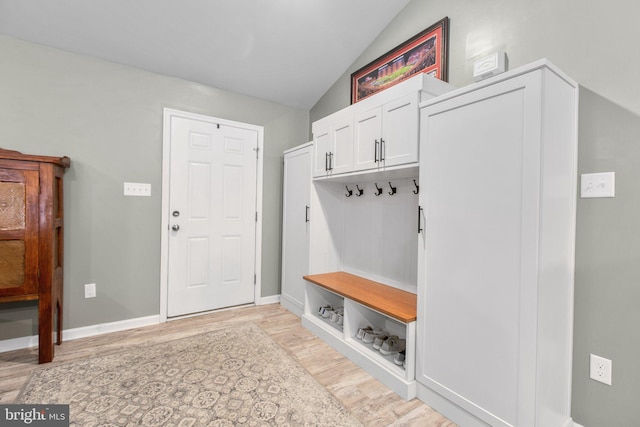 mudroom with light hardwood / wood-style floors and lofted ceiling