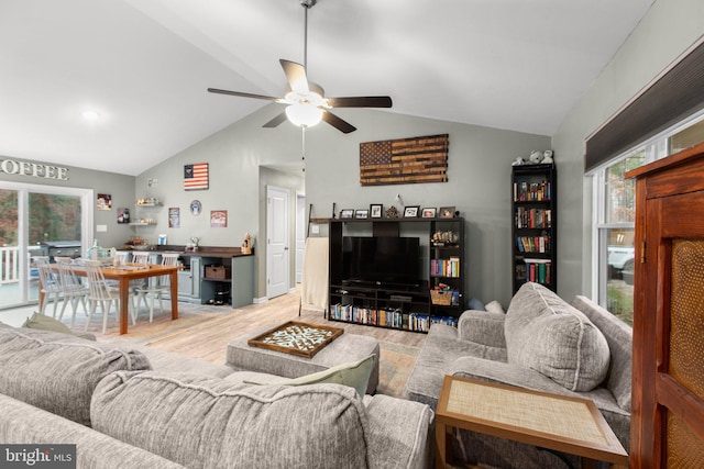 living room featuring ceiling fan, vaulted ceiling, and hardwood / wood-style flooring