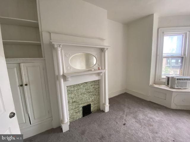 unfurnished living room featuring cooling unit and carpet floors