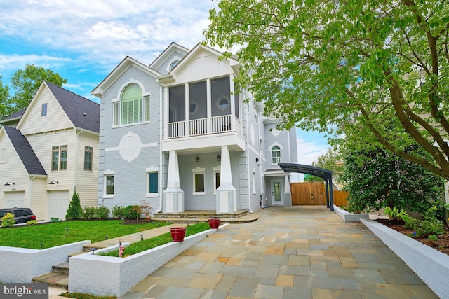 view of front of property with a sunroom and a garage