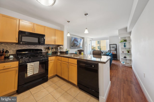 800 4th St SW Unit S312, Washington, DC 20024 - kitchen with black appliances, a peninsula, backsplash, and open floor plan